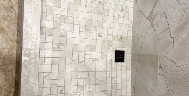 Tiled shower room floor and backsplash