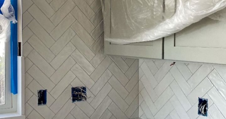 A kitchen remodeling project with installed tiles as kitchen backsplash